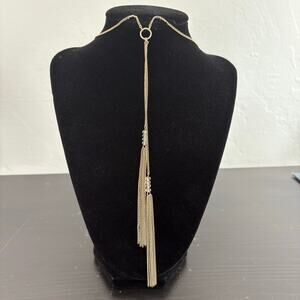 World Market Gold tone lariat style necklace with clear beaded tassels. 28 in